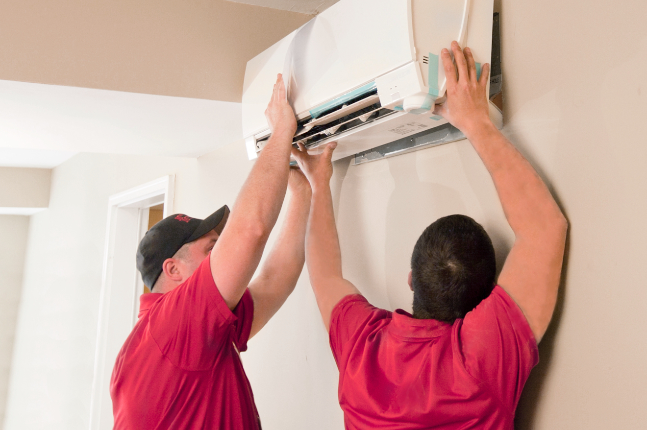 Workers installing an HVAC unit